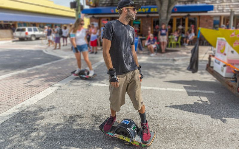 onewheel with accessories riding on street