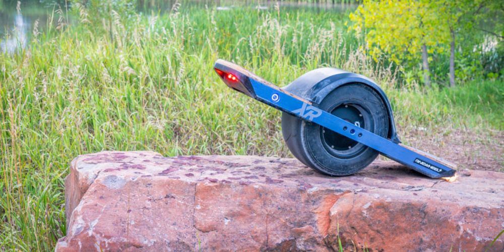 onewheel with fender sitting on a rock